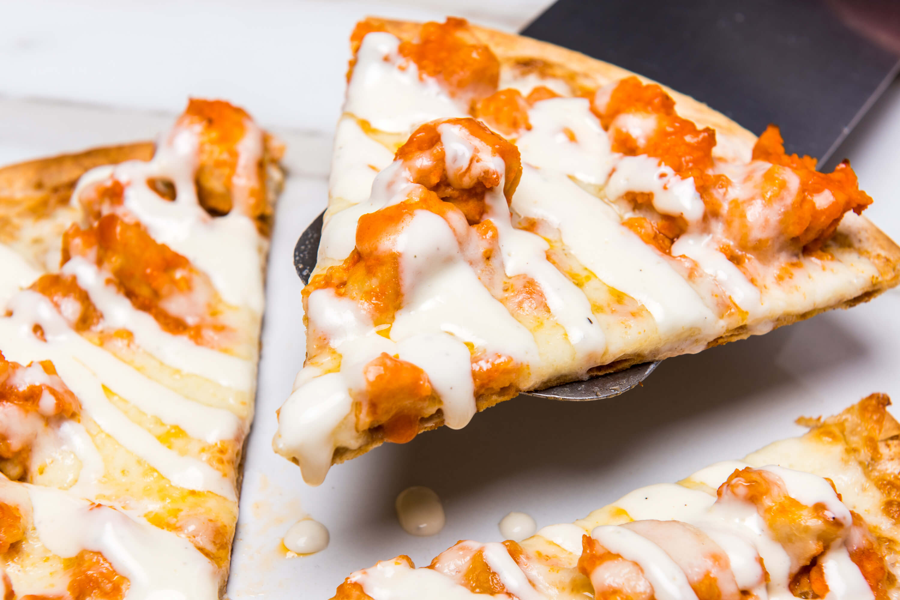 pieces of pizza with drizzled sauce